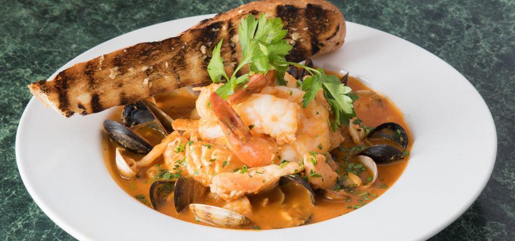 SF Cioppino · Jumbo prawns, clams, Chilean sea bass, rockfish, salmon, snow crab, in tomato white wine broth, topped with a grilled baguette.
