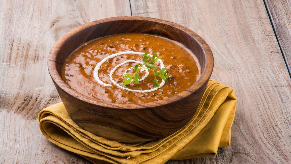 Dal Makhani (DM) · Black Lentils cooked with Herbs & Spices, then sautéed in Butter & garnished with Fresh Corianders. Served with Basmati Rice.