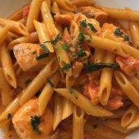 Penne with Tomato Cream Sauce · Penne pasta with fresh salmon with pink vodka sauce.