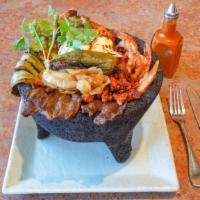 Land Molcajete · Charbroil chicken, Beef steak, chorizo and cactus, topped with artisan cheese on our special...