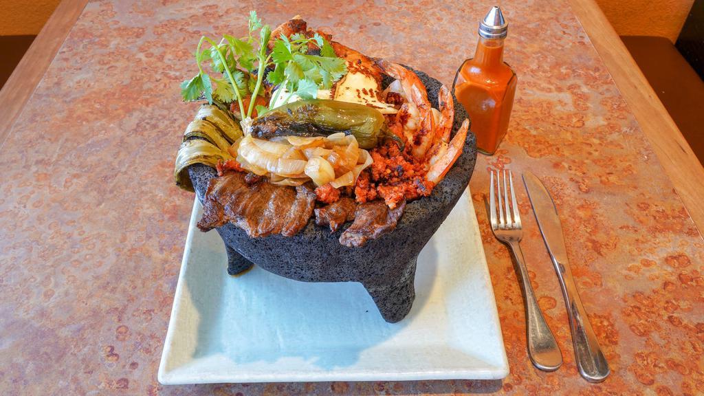Land Molcajete · Charbroil chicken, Beef steak, chorizo and cactus, topped with artisan cheese on our special salsa.