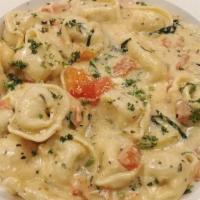 Tortellini · Tortellini filled with 3 cheeses sautéed with garlic, tomato and black olives and herbs on c...