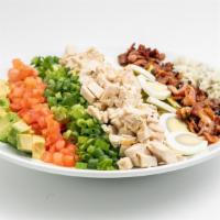 Cobb Salad · Romaine lettuce, tomatoes, bacon, chicken, hard-boiled eggs, avocado, green onions & crumble...