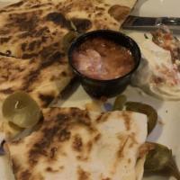 Veggie Quesadilla · Grilled bell peppers, onions, mushrooms. Topped with olives, jalapeños, sour cream, flour to...