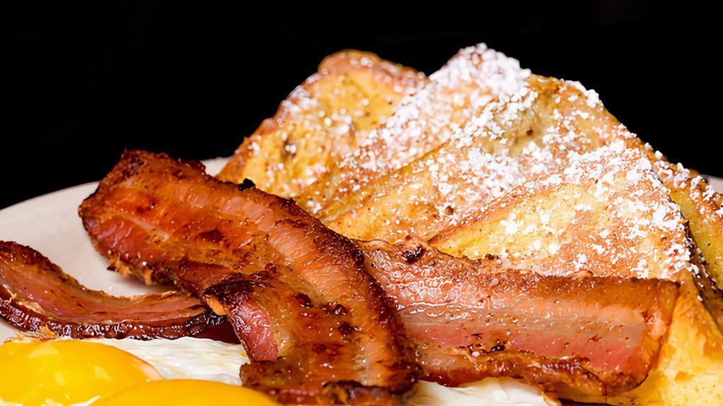 The French Toast Supreme · Three french toasts with two sausage links or three bacon strips or two sausage patties and two eggs.