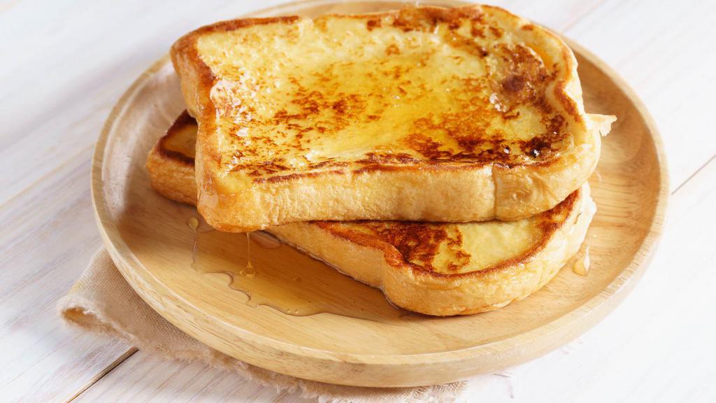The Traditional French Toast · Fresh fluffy french toasts cut into 3 slices with butter and syrup.