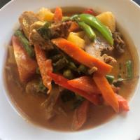 26. Kang Ped (Duck Red Curry) · Boneless roasted duck, tomato, bell pepper, pineapple, and sweet basil in coconut milk.
