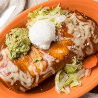 Super Famoso Burrito · Big burrito topped with enchilada sauce, cheese, sour cream & guacamole. Served with rice, b...