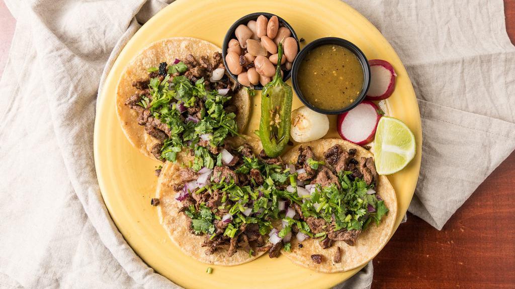 Authentic Tacos · Three soft shell taquitos topped with your choice of meat, onions & cilantro. Choose from carne asada, carnitas, pollo adobado, pastor or shrimp.