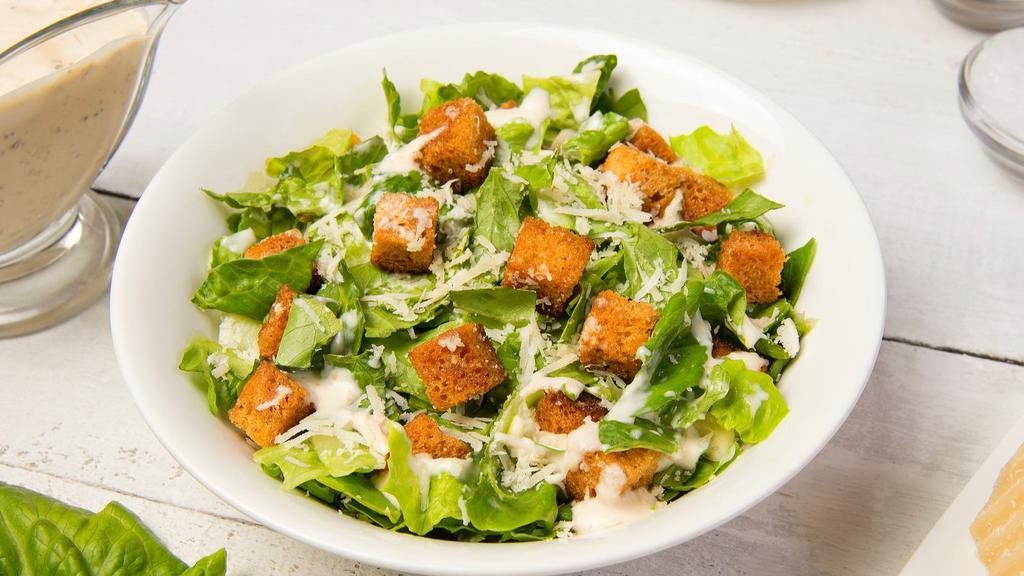 Caesar Salad · Fresh, crisp romaine lettuce with crunchy croutons and shredded Parmesan cheese.
