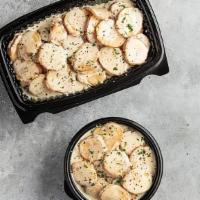 Potatoes Au Gratin · Sliced potatoes baked with Parmesan cheese, garlic, and butter