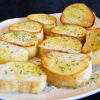Garlic Bread · Four pieces of our Italian style bread. Brushed with garlic and butter, a little parsley and...