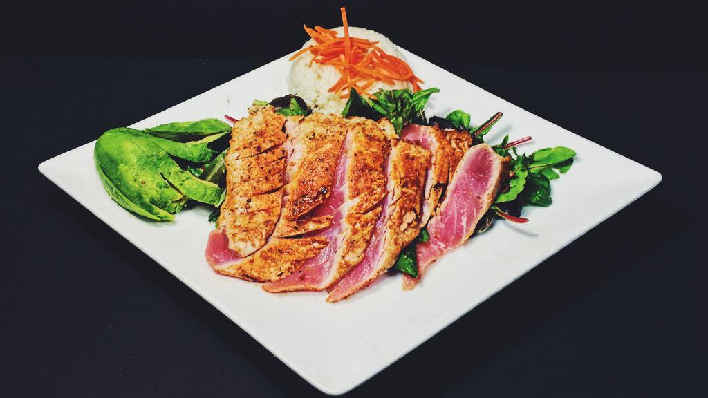 Seared Ahi · Blackening-spiced ahi, baby greens, carrots, toasted almonds, red onions, pickled ginger, crispy wontons, and orange champagne vinaigrette.
