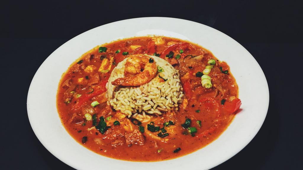Spicy Jambalaya · Blackened chicken, creole shrimp, Portuguese linguiça, red peppers, yellow onions, green onions, Cajun sauce, and rice pilaf.