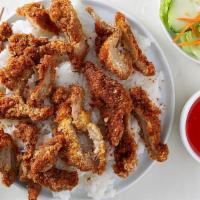 94. CƠM GÀ CHIÊN DÒN · crispy chicken over rice served with sweet and sour sauce
