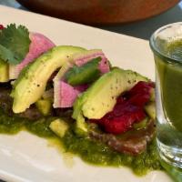 Aguachile Verde · Prawns marinated w/ lime juice, cucumber, avocado,  serrano pepper & radishes. Served w/ tor...