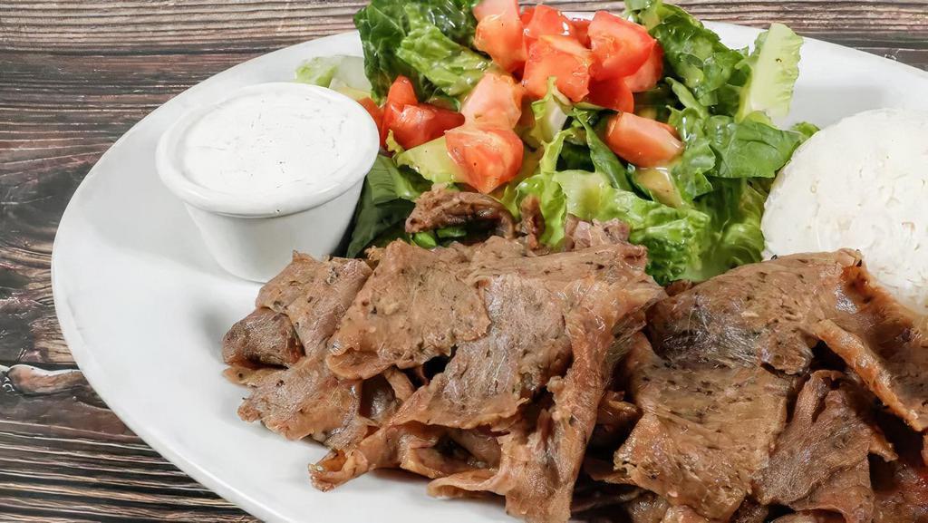 Doner Kebab Plate · Gyro platter. Lamb and beef sliced meat, served salad, rice, tzatziki sauce, chili sauce, and hummus pita bread.
