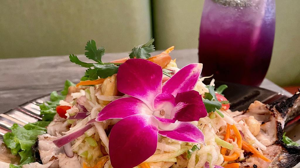 Grilled Rainbow trout · Grilled rainbow trout topped with shredded green apples, red onions , green onions, cashew nuts, tossed coconut meats, carrot mixed with house special dressing.
