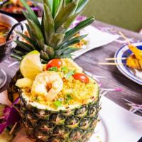 Pineapple Fried Rice · Fried rice with pineapple, chucks, yellow onions, tomatoes, egg, peas, carrots, and cashew n...