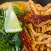 Khao Soi Curry Noodle  · Egg noodle, chicken leg, pickle lettuce, red onion, lime, cilantro,  creamy broth topped wit...
