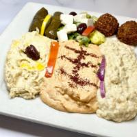 9. Appetizer Combo Plate · Hummus, eggplant salad, dolma, cacik, cheeseroll, tabouleh, and falafel.