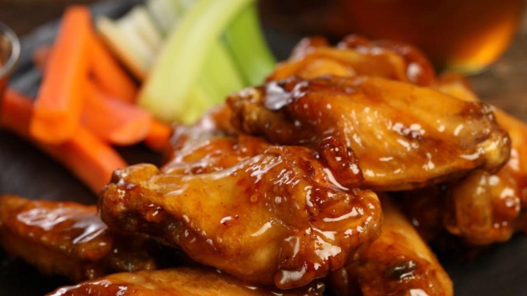 Traditional Hot Honey Wings · 8 hot honey wings (medium heat), served with carrots & celery and a choice of blue cheese, classic ranch, or sriracha ranch for dipping.