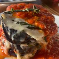 Tortino di Melanzane Alla Parmigiana · Baked eggplants with fresh tomatoes sauce, basil, smoked mozzarella cheese and Parmigiano Re...
