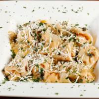 Ravioli di Zucca · Homemade butternut squash ravioli topped with salty ricotta cheese in a brown butter and sag...