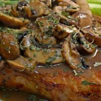 Filet De Veau Aux Truffles Et Champingnons · Roasted veal chop with savory truffle and mushroom sauce.