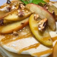 Pancakes with Caramelized Bananas · Two pancakes with caramelized bananas & roasted walnuts topped with drizzled caramel sauce &...