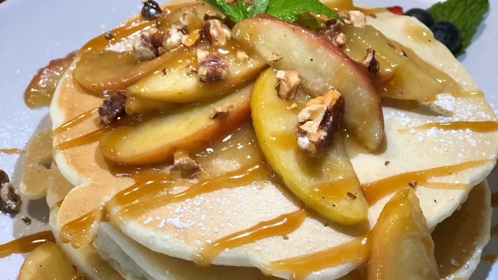 Pancakes with Caramelized Bananas · Two pancakes with caramelized bananas & roasted walnuts topped with drizzled caramel sauce & whipped cream.