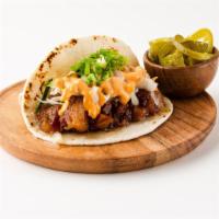 Caramelized Pork Belly Taco · Toasted flour tortilla topped with braised caramelized porkbelly, sweet pickled daikon and c...