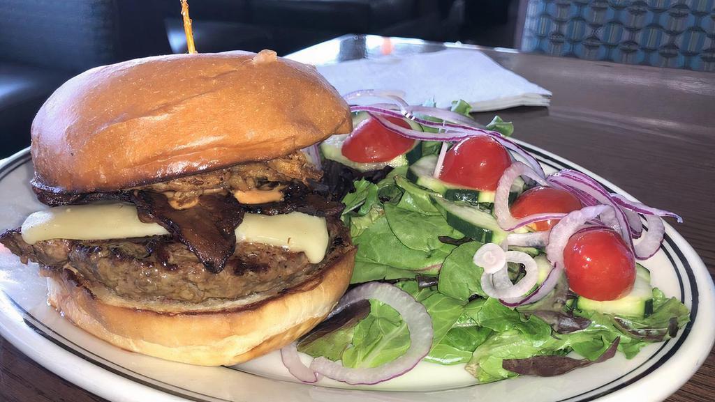 Jack’s Prime Classic Hamburger · 1/3 lb. seasoned Angus Beef patty with sea salt and black pepper, iceberg lettuce, kosher dill pickle, red onions, tomatoes, and prime burger sauce. Served with medium well niman ranch beef and panorama bakery American burger bun.