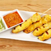 ChickenSatay · Grilled skewered chicken  marinated with Thai herbs and spices. Served with peanut sauce and...