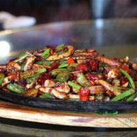 1. House Special Sizzling Tentacles of Squid 铁板秘制鱿鱼须 · Super hot.