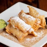 Tequeños · Crispy wontons stuffed with Oaxaca cheese served with avocado and tamarind sauce.