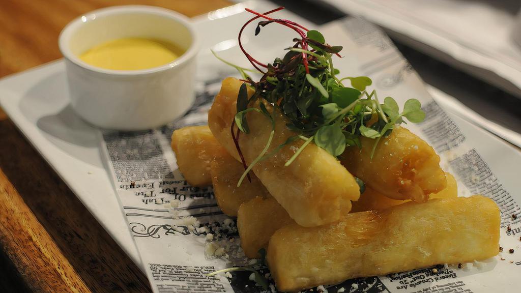 Yucca Fries · With huancaina sauce and queso rayado.