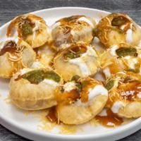 Dahi Batata Sev Puri · Round crispy wafers served with potato, yogurt, chickpeas and chutney sprinkled with sev.