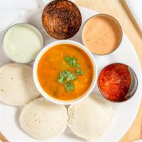 Idli (3 Pcs.) · Steamed rice cake made of black lentils and rice. Served with sambar and chutney.