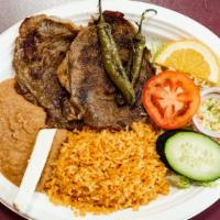 Carne Asada · Served with rice, beans, salad y tortillas.
