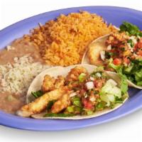 Fish Taco Plate · Two fish tacos topped with lettuce and pico de gallo accompanied with rice and beans.