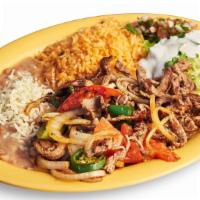 Bistec Ranchero Plate · Mild Spicy. Steak grilled with onions, tomatoes, and jalapeños. Includes rice, beans, guacam...