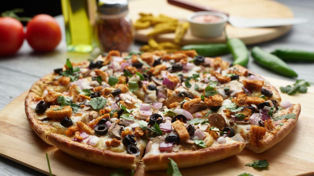 Curry Chicken Pizza Twist · This pizza has our signature curry sauce, our signature All-Natural Curry Chicken Breast, fresh diced mozzarella cheese, fresh mushrooms, crisp red onions, sliced black olives, fresh diced; garlic, ginger & green chilies, garnished with fresh cilantro.