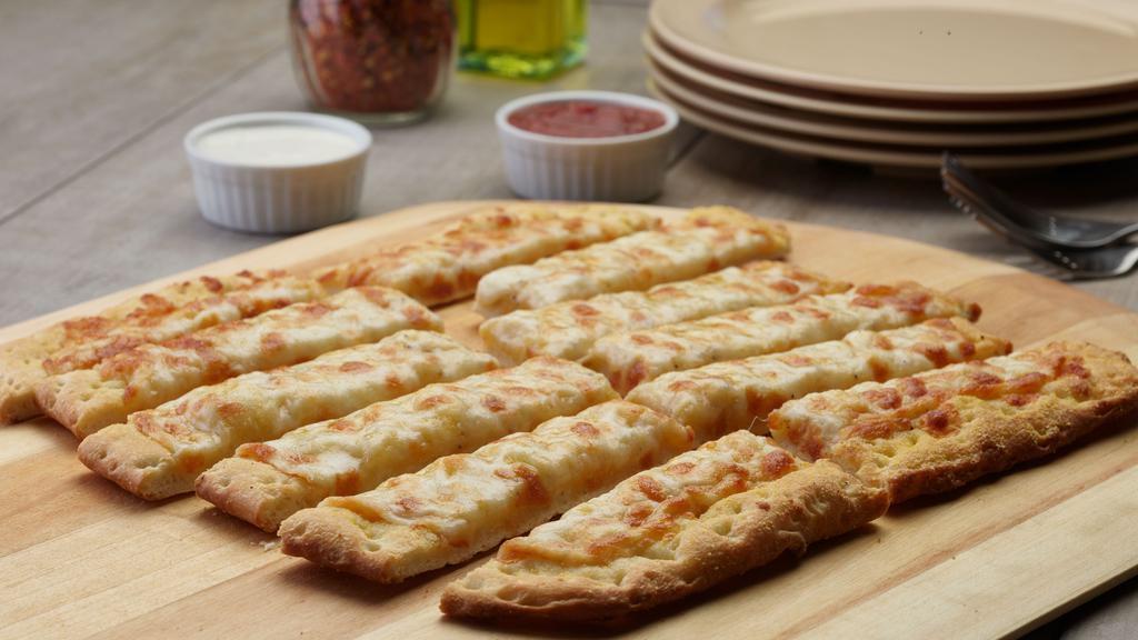 Cheesy Garlic Bread · These breadsticks have our signature garlic spread and fresh diced mozzarella cheese.