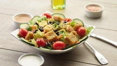 Garden Salad · This salad has fresh crisp romaine lettuce, juicy cherry tomatoes, fresh cucumber slices, sliced olives, crunchy croutons, grated parmesan cheese, and crisp carrot slices. Dressing on the side.
