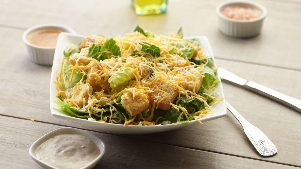 Caesar Salad · This salad has fresh crisp romaine lettuce, crunchy croutons, grated parmesan cheese & our signature Caesar dressing on the side.