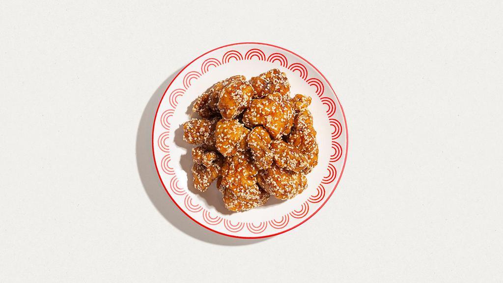 Sesame Chicken · Crispy chicken coated in sweet savory sauce with sesame seeds.