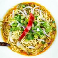 Kao Soy · Steamed egg noodle and pickled green mustard topped with chicken yellow curry, red onions, s...