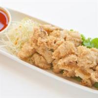 Pla Mauk Tod · Golden fried calamari served with sweet and sour sauce.