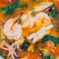 Tom Yum Soup · Hot and sour soup with shrimp-chili paste, lemongrass, galanga, kaffir lime leaves, red and ...
